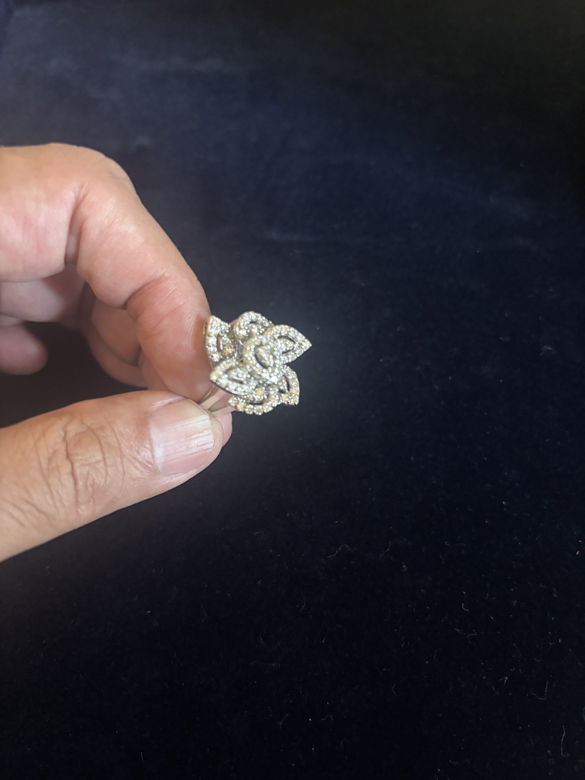 Floral diamond ring held in hand